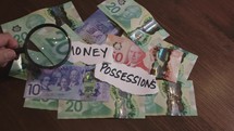 magnifying glass over money and possessions
