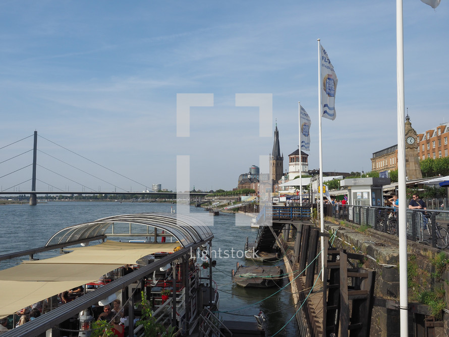 DUESSELDORF, GERMANY - CIRCA AUGUST 2019: People on Rheinuferpromenade on the bank of river Rhein in the Altstadt (old town)