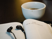 headphones, earbuds, iPhone, open Bible, Bible, The New Testament, title page, coffee, mug 
