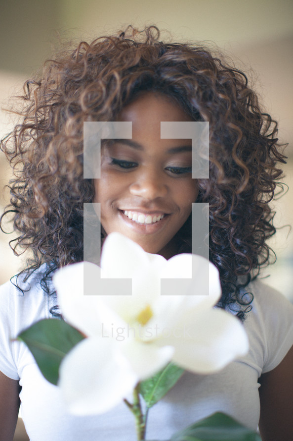 teen girl holding a magnolia flower