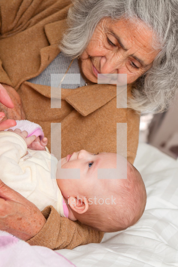Grandmother holding infant.