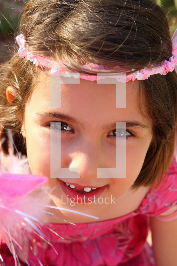 little girl with missing teeth dressed like a princess