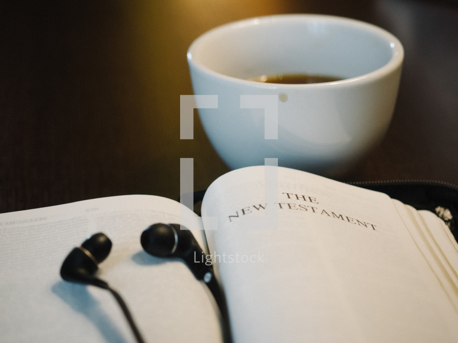 headphones, earbuds, iPhone, open Bible, Bible, The New Testament, title page, coffee, mug 
