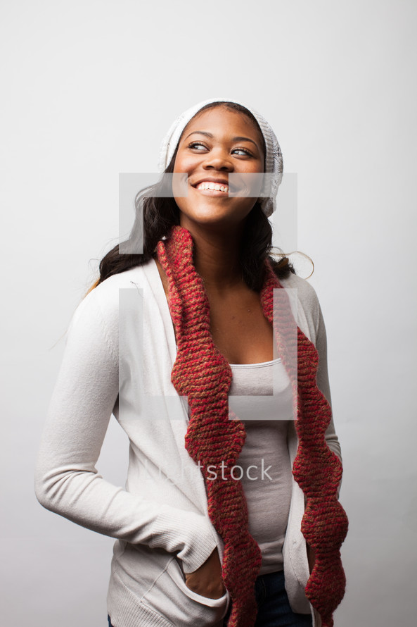 A happy woman wearing a scarf and hat. 