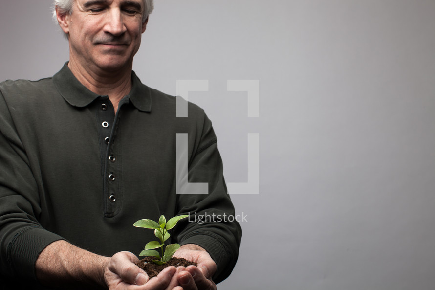 man holding a plant 