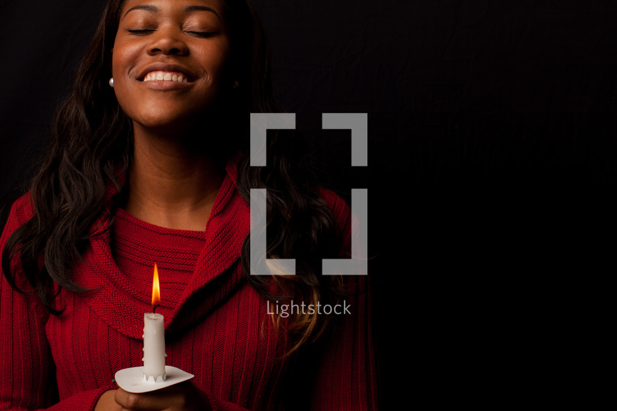 A woman holding a candle. 