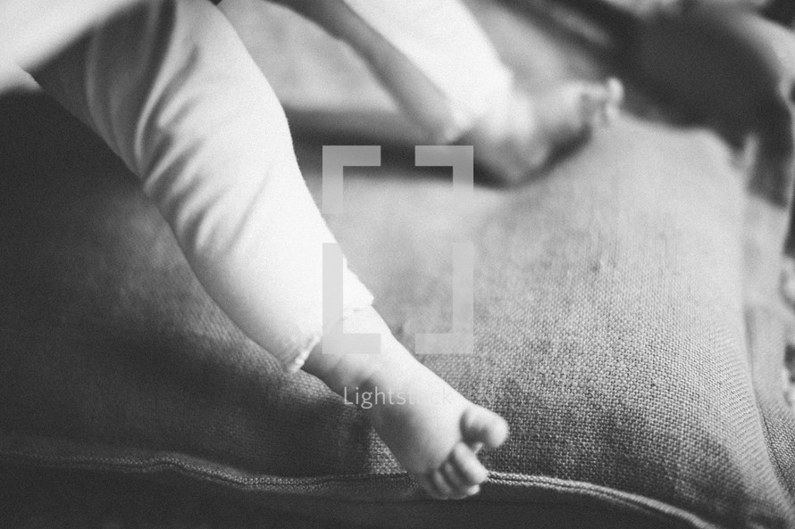 feet of an infant on a pillow