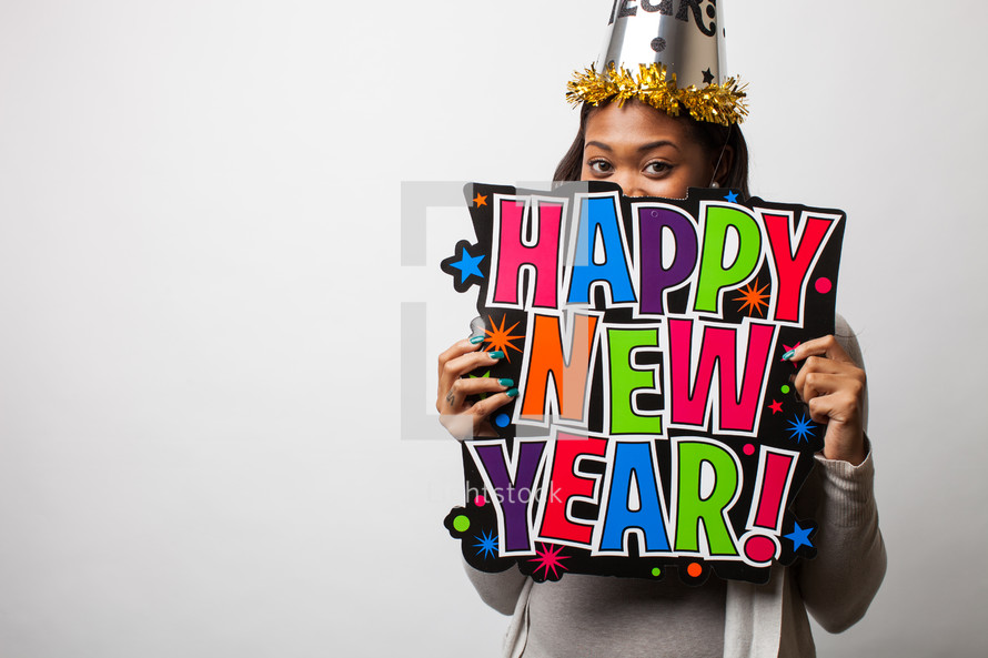 Woman holding a Happy New Year sign. 