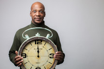 man holding a clock 