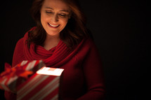 Opening a gift box - An illuminated gift - the gift of salvation through Jesus Christ 