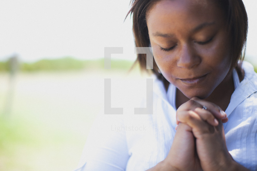 African-American woman with praying hands 