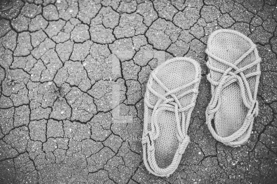 Rope sandals on the craked earth.