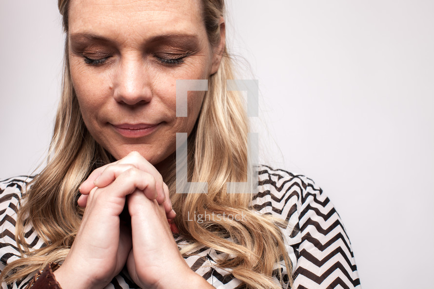 woman in prayer with closed eyes 