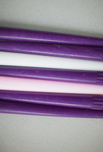 row of purple, pink, white, advent, candles, candle sticks 