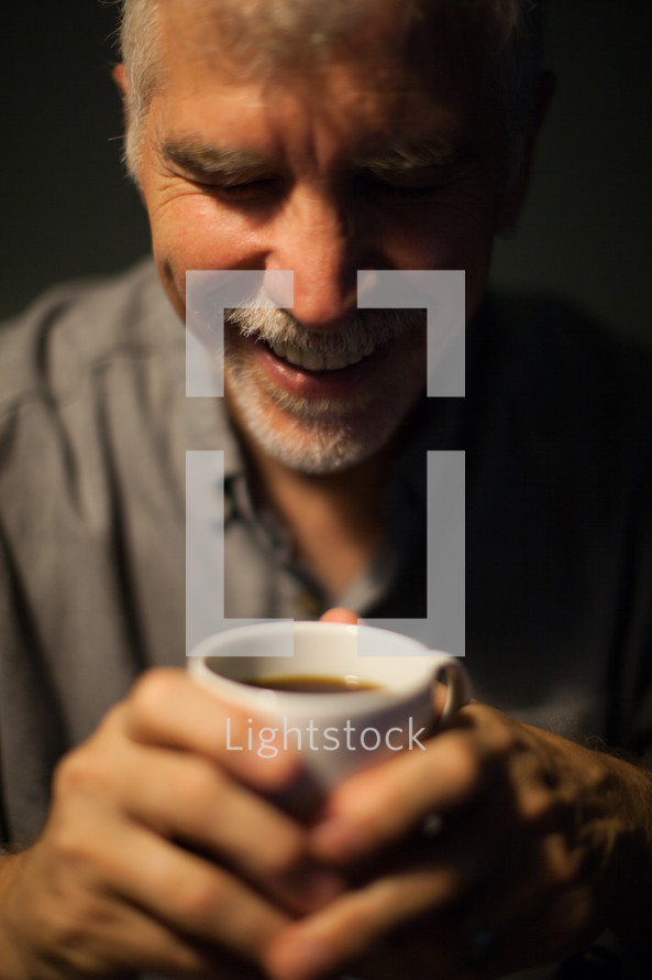 man drinking a cup of coffee
