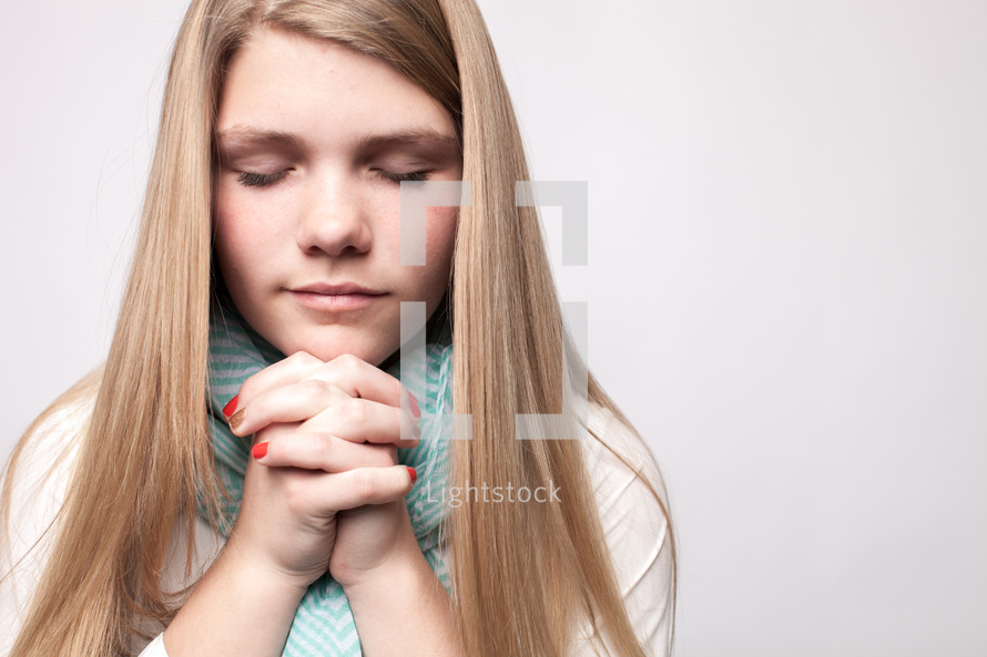 teen girl with praying hands 