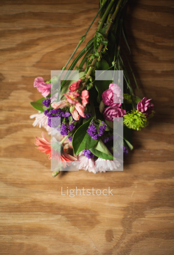 Bouquet of flowers on a wood panel.