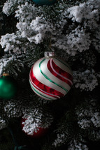 ornament hanging on a flocked Christmas tree