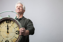 man holding a clock at midnight 