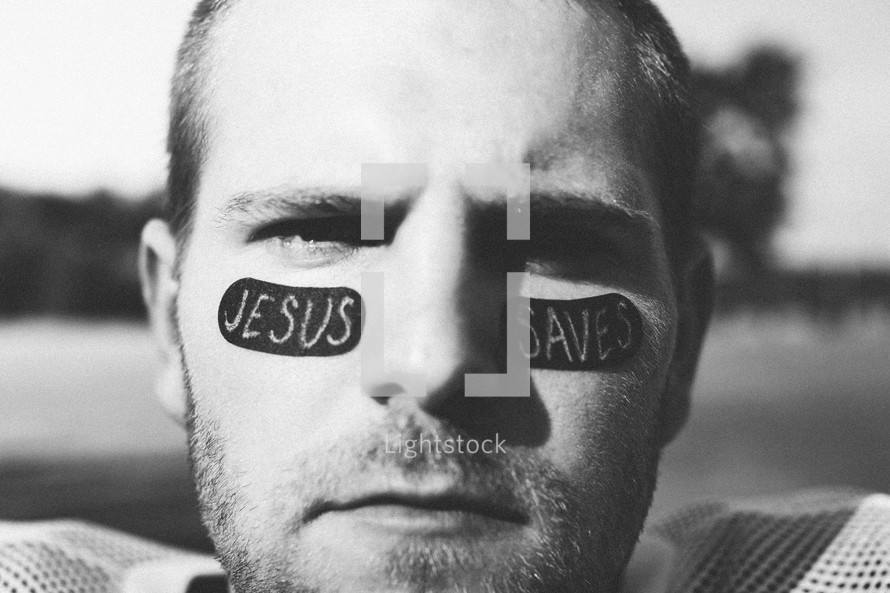 football player with Jesus Saves on his face 