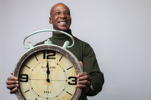 man holding a clock 