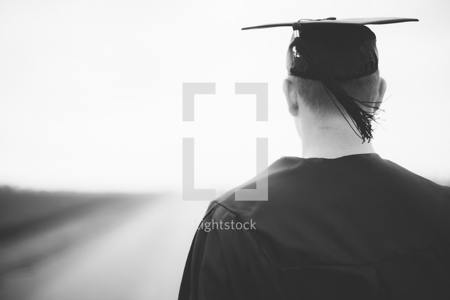 Graduate standing in the middle of the road.