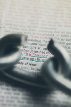 Broken chain link over Bible text -- John 19:30.