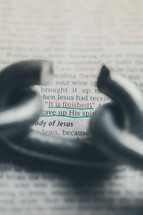 Broken chain link over Bible text -- John 19:30.