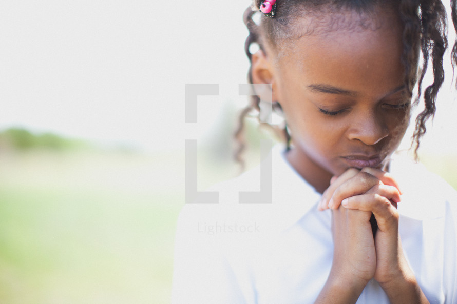 Young african-american girl with praying hands — Photo — Lightstock