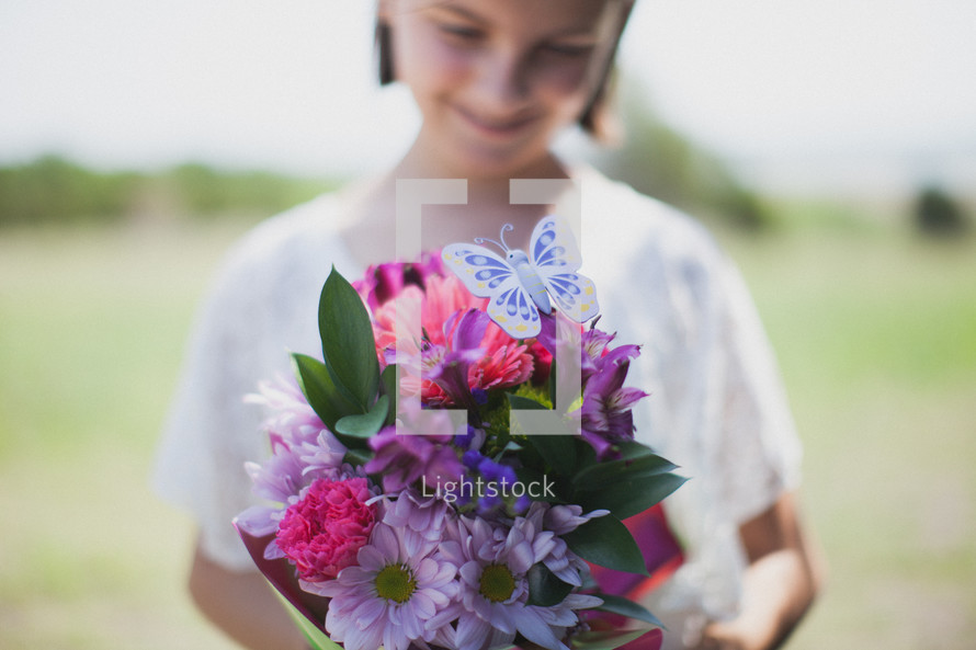 young girl holding a bouquet of flowers 