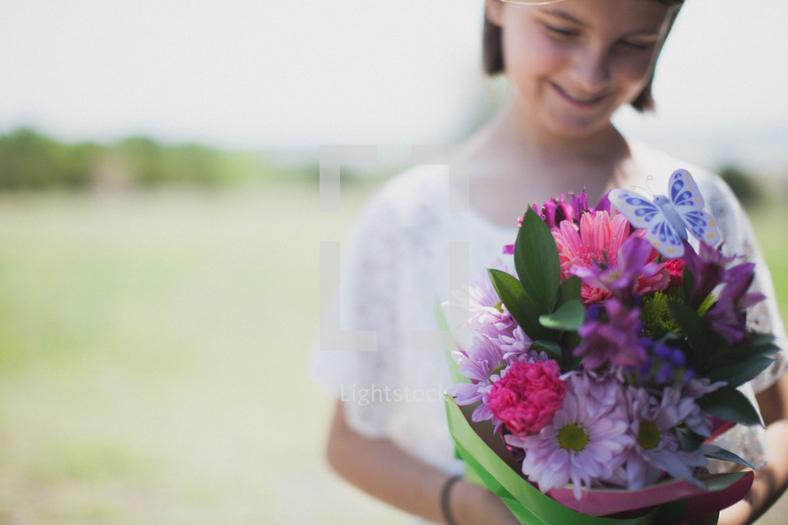 young girl holding a bouquet of flowers 