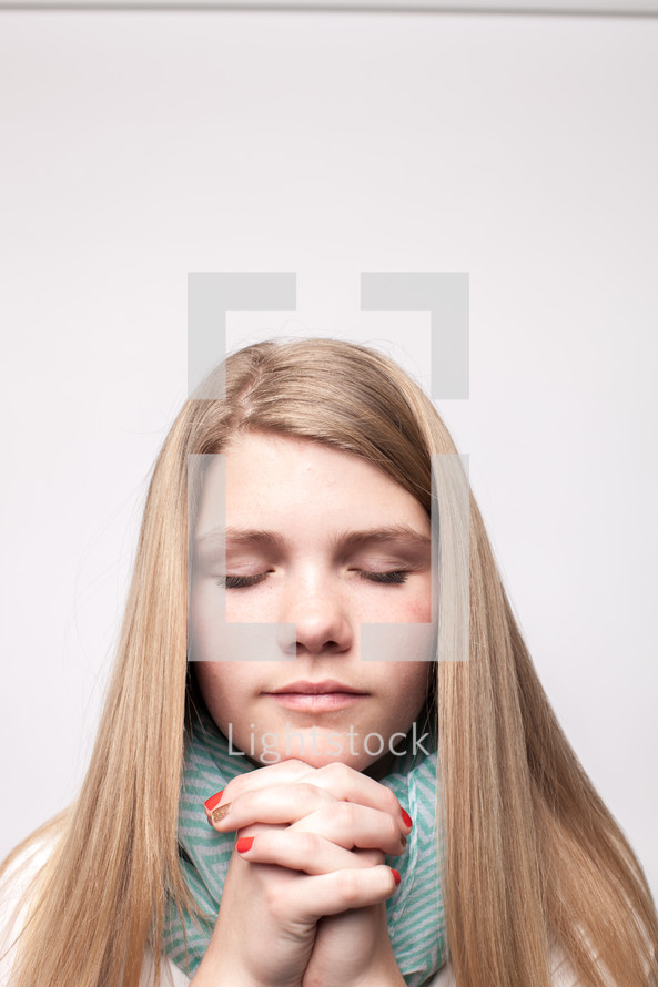 young woman with praying hands 