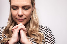 woman in prayer with closed eyes 