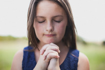 girl child with praying hands 