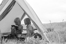 children reading Bibles in a tent 