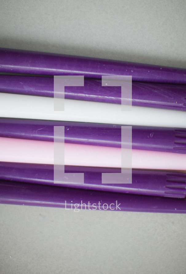 row of purple, pink, white, advent, candles, candle sticks 