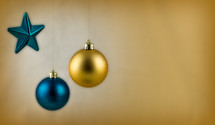 Blue and gold hanging Christmas ornaments.