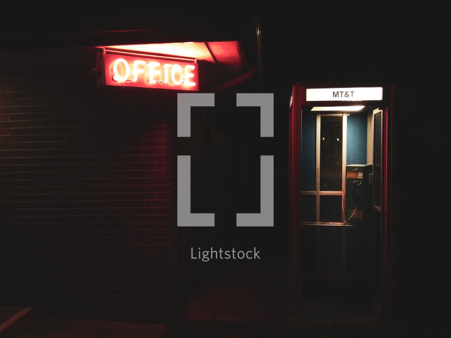 glowing office sign and telephone booth 