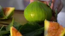 Cutting green fig in half