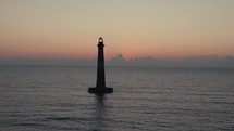 A lighthouse on the  Atlantic Ocean coast of South Carolina during sunrise 