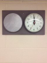 clock and speaker on a wall 