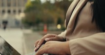 Young business woman walking around the city using her phone and laptop