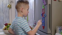 Boy playing with magnetic figures