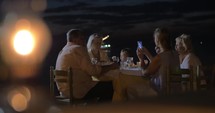 Family sitting at a table in evening in city Perea, Greece