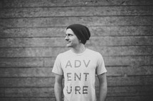 side profile of a man wearing an Adventure t-shirt 