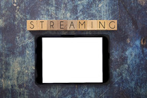 tablet on a blue grunge background - streaming 