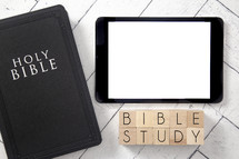 Bible and tablet on a white wood background - Bible study 