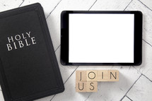 Bible and tablet on a white wood background - join us 