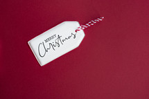 Merry Christmas tag on red background