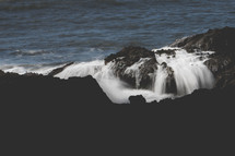 waves crashing over rocks 